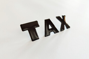 Tax reminder message. Black TAX letters on a white background. 