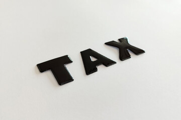 Tax reminder message. Black TAX letters on a white background. 