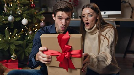 happy young woman and man with gift box in festive room, christmas decorations - Powered by Adobe
