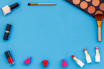 Frame of various makeup tools and cosmetics products, top view
