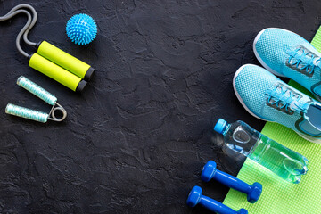 Top view of gym sports equipment with sneakers and dumbbells. Wellness concept