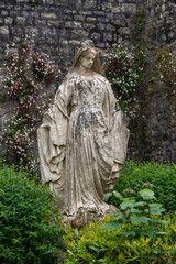 Female statue in a garden, Bayeux, Normandy, France