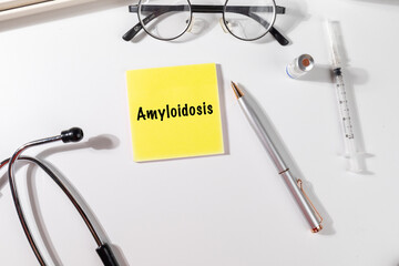 Doctor’s Desk with Note “Amyloidosis” – Protein Build-Up Disorder Reminder with Pen and...