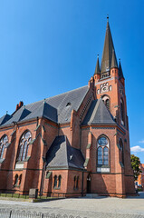 historic, neo-gothic, church with clock tower in the city of Drezdenko