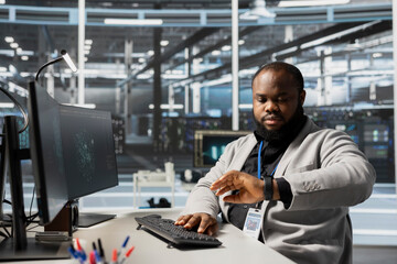 Data center engineer checking clock at work, waiting for job shift to end while verifying neural network parameters. Stressed server hub worker checking watch, pressured by deadline