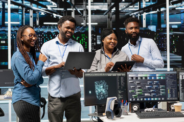 Cheerful data center experts working together, using deep learning algorithms and node trees to...