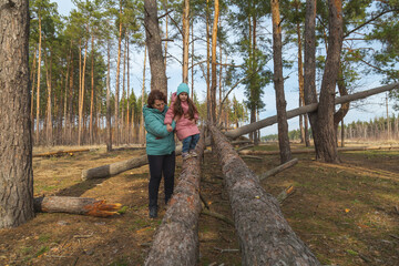 grandmother with granddaughter walking and playing in nature in the forest