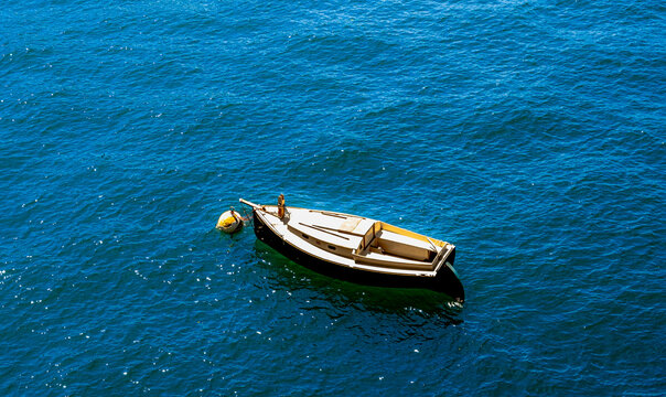 Small boat on the bluw waters of Lake Como, Italy