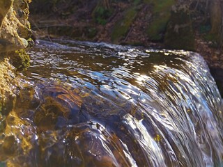 Wildlife. Mountain river. Thresholds of water sources. Transparent water. Movement of water in nature. Close-up. refreshing condition Wallpaper. Postcard