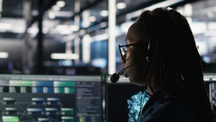 Data center expert examines node tree interface, delivering technical support. Server room...