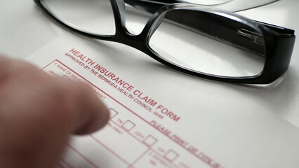 Finger tapping on health insurance claim form