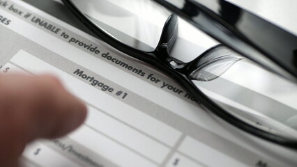 Finger tapping on mortgage form