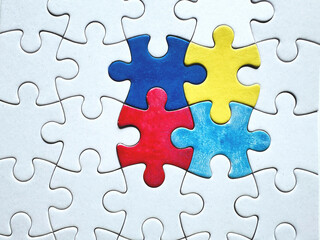 Colorful puzzle pieces symbolizing Autism Awareness Day on a white background