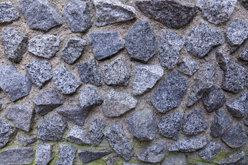 Rough natural granite stone wall pattern with textured gray stones and concrete filling, perfect for 3D rendering backgrounds, digital design textures, architectural documentation, and stone structure