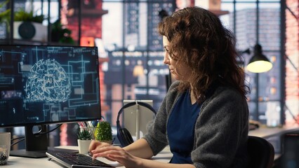 Female system admin doing maintenance on AI brain pc systems, sitting at office desk. Girl works as...