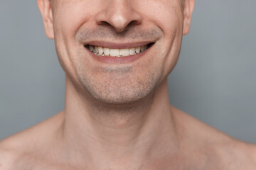 Obraz premium Smiling man after shaving on grey background, closeup