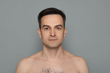 Portrait of man after shaving on grey background