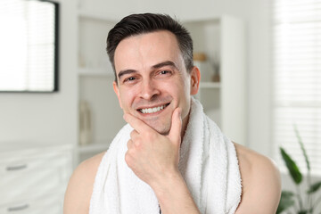 Portrait of smiling man after shaving at home