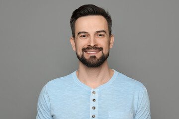 Smiling man before shaving on grey background