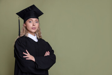 Student with crossed arms after graduation on green background. Space for text