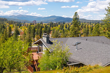 View from a mid century hillside home of McEuen Tower in the downtown district and the hills of the city of Coeur d'Alene, Idaho, from the Fernan Lake area.
