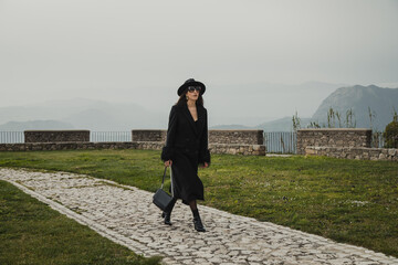 Elegant Woman Walking On The Stone Path Inside The Square Near The Castle