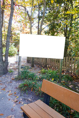 blank white sign in a rural wooded park area