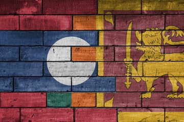 Fototapeta premium colourful painted big national flag of sri lanka and flag of laos on a massive old brick wall background. concept