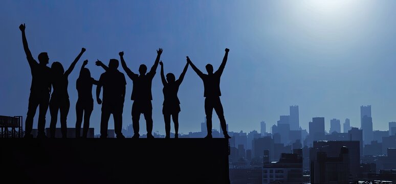 Triumphant team atop urban skyline