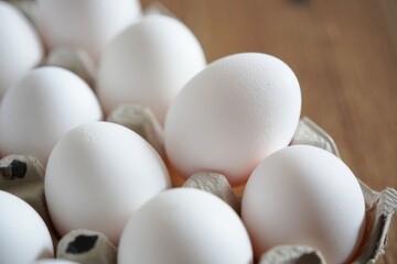 Fresh White Eggs in Carton on Wooden Tabletop Ready for Cooking and Baking Healthy Breakfast