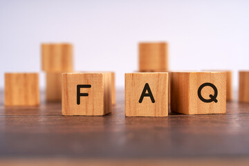 wooden block with FAQ written on the table, frequently asked question concept, customer support,...