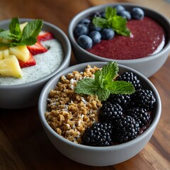 Three healthy bowls with fruit and granola