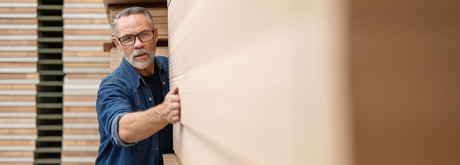 Carpenter working on wooden plank in workshop. Craftsman makes own successful small business, man...