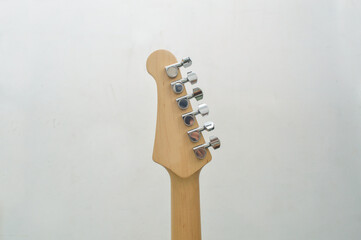Backside, Headstock of a brown six-string classic electric guitar, on a white background