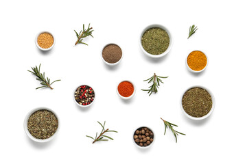 Composition with bowls of different spices and rosemary on light background