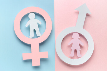 Paper symbols of male and female with couple figures on color background