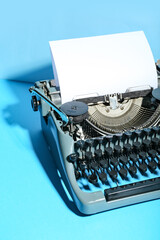 Vintage typewriter on blue background