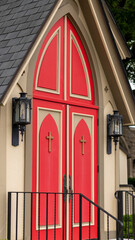 Fototapeta premium front of an Episcopalian church in Springfield missouri. double, red doors with pitched roof. historical has black and glass old fashioned lights. 