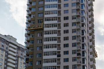 Fototapeta premium Finishing of multi-storey building facades