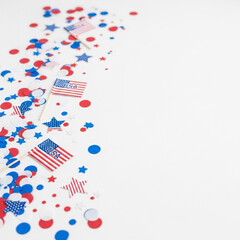 Obraz premium Minimal desktop flat lay with red, white, and blue confetti, USA-themed paper decorations, stock-ready scene