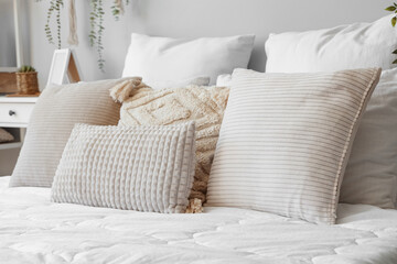 Cozy bed with soft pillows, closeup