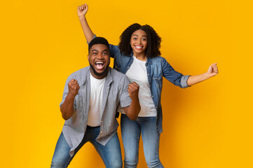 Lucky Winners. Portrait Of Euphoric Young Black Couple Emotionally Celebrating Success, Raising...
