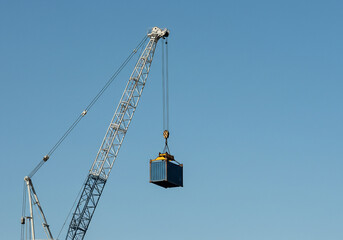 Usa china international trade war container crane lifting cargo against clear blue sky industrial equipment transportation and logistics