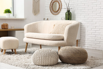 Interior of modern living room with sofa and poufs