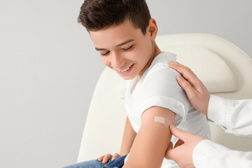 Little boy receiving plaster after vaccination in clinic