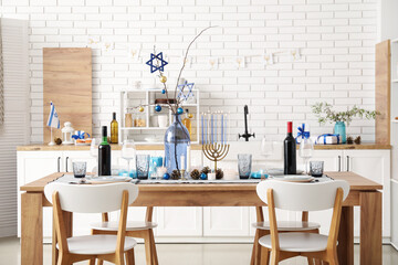 Festive table setting with Hanukkah decorations in kitchen