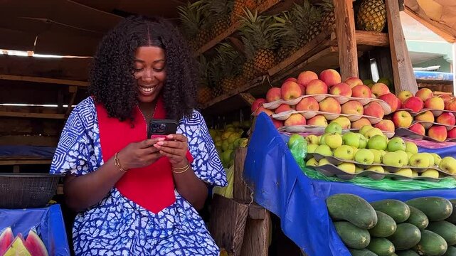 saleswoman smiling using phone in market place