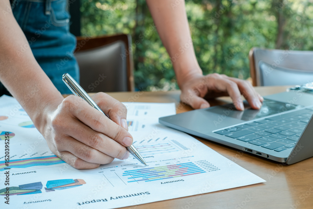 Aufkleber close-up of hands working on financial charts and graphs with a laptop, showcasing business analysis