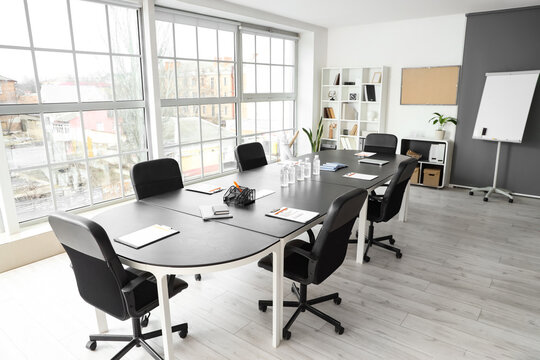 Interior of office with table prepared for meeting