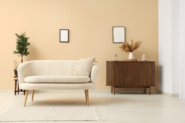 Wooden cabinet and comfortable sofa in interior of modern living room